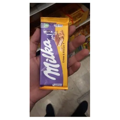 Milka шоколад с молочным кремом и печеньем, 100 г